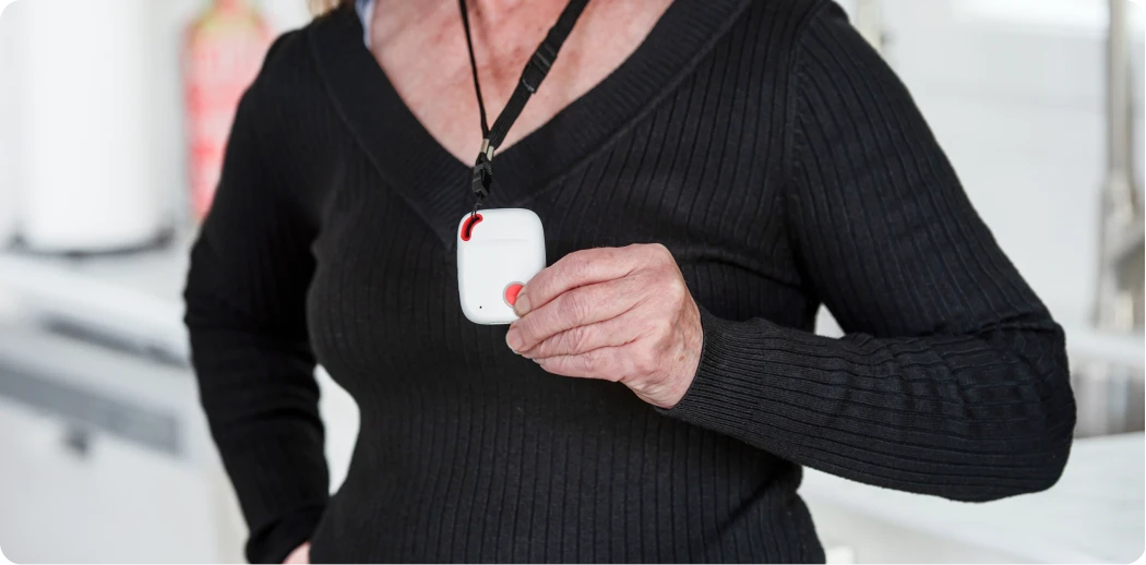 zoomed in on fall detection monitor held proudly by lady