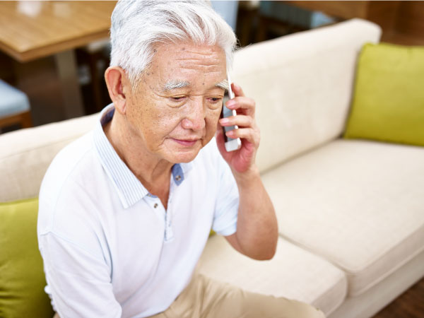 elderly asian man on the phone