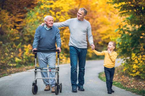 Grandpa with adult son and young grandson walking