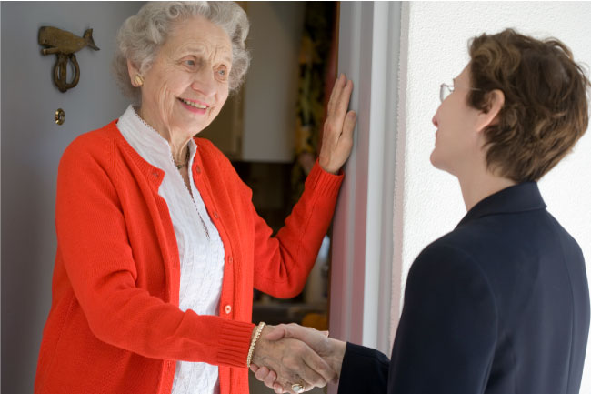 Senior woman at front door