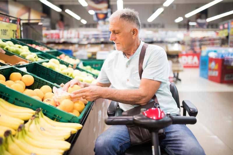 elderly-man-at-the-grocery-store-in-mobility-scooter