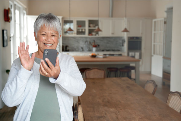 elderly woman smiling talking on phone