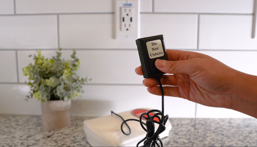 plugging in home cellular power adapter into outlet