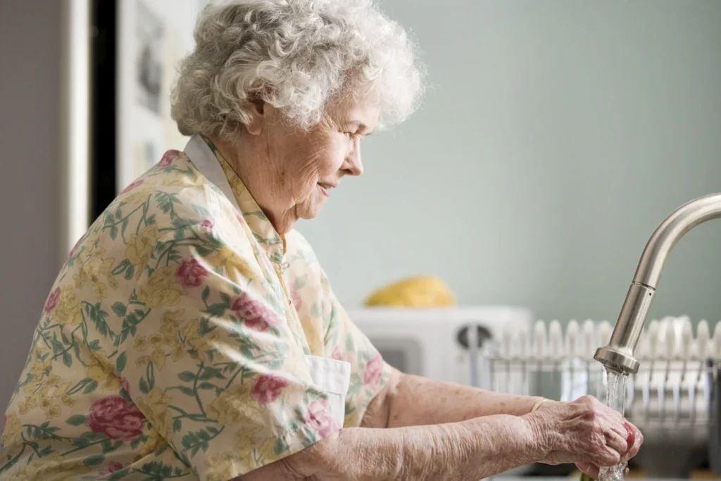 Senior woman washing hands