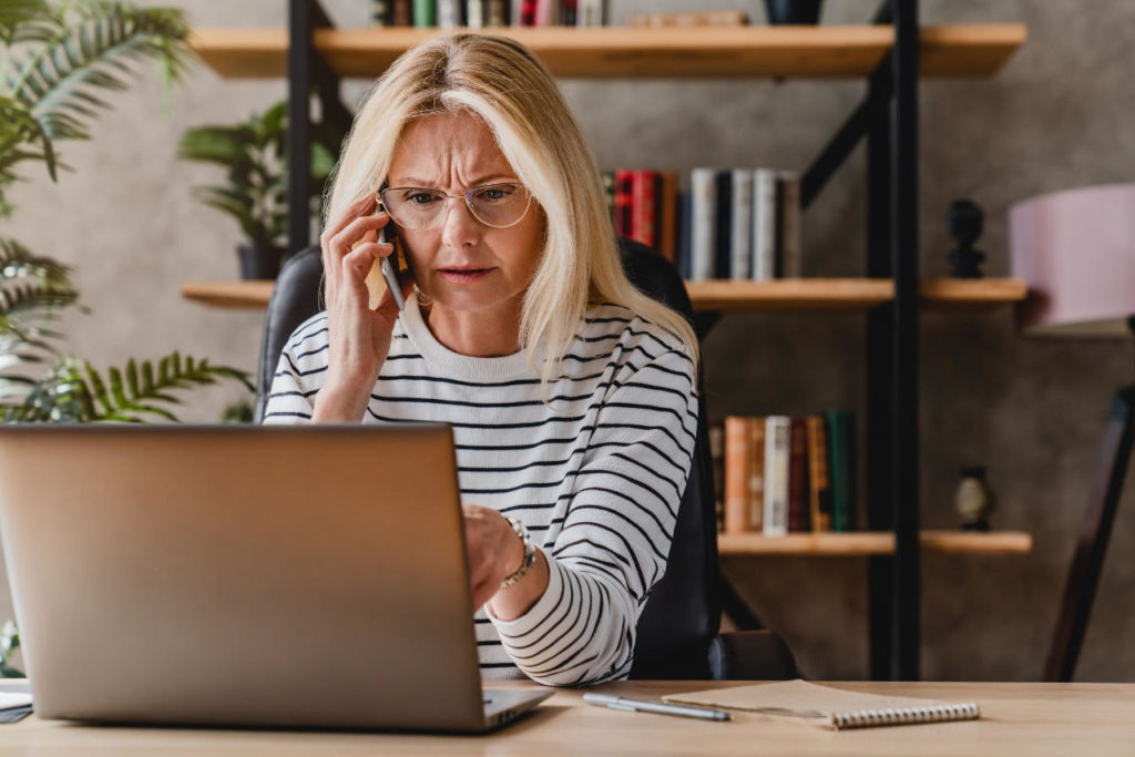 Woman on computer, she looks troubled